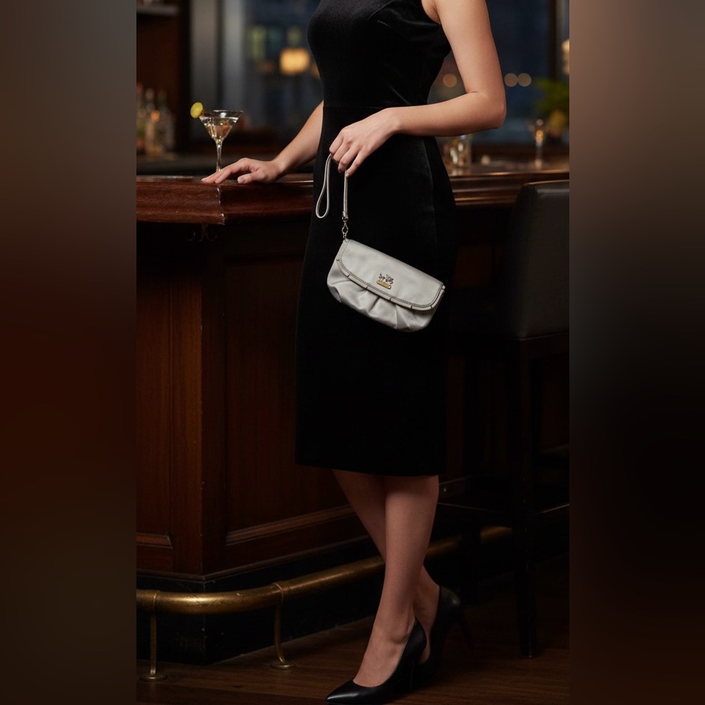 This is a Coach gray satin evening wristlet clutch bag.